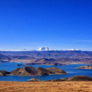 Sunrise over Yamdrok Lake, Tibet – A tranquil morning view of snow-capped mountains reflecting on the turquoise water