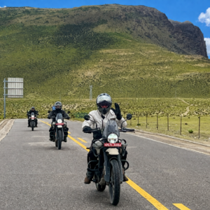 Motorcyclists riding the Friendship Highway through the Tibetan Plateau landscape