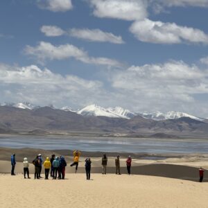 Group of tourists enjoying sand dunes and Tibetan Plateau scenery on the way to Mount Kailash in western Tibet
