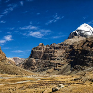 Mount Kailash sacred mountain in Western Tibet with snow-capped peak and pilgrims on the kora route during the 2026 Year of the Horse pilgrimage